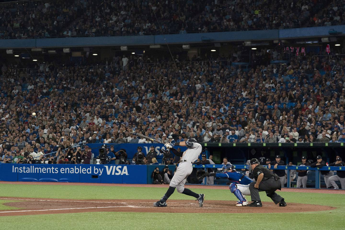 New York Yankees' Aaron Judge  hits his 61st home run of the season, a two-run homer against the Toronto Blue Jays during seventh inning of a baseball game Wednesday, Sept. 28, 2022, in Toronto. (Alex Lupul/The Canadian Press via AP)
