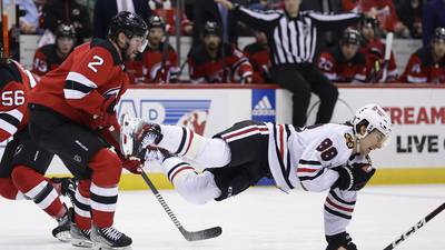 Connor Bedard exits with an injury early in the Chicago Blackhawks-New Jersey Devils game
